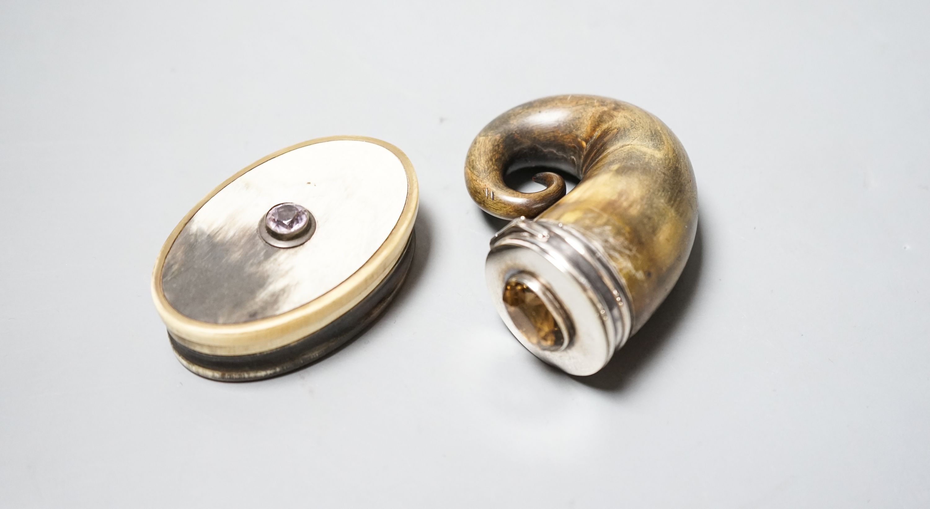 A 19t century white metal and gem set mounted horn snuff mull(a.f.)78mm and a similar oval horn snuff box.